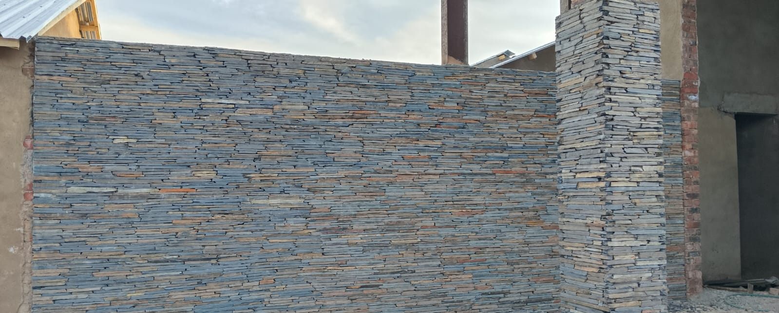 Grey slate feature wall with matching pillar