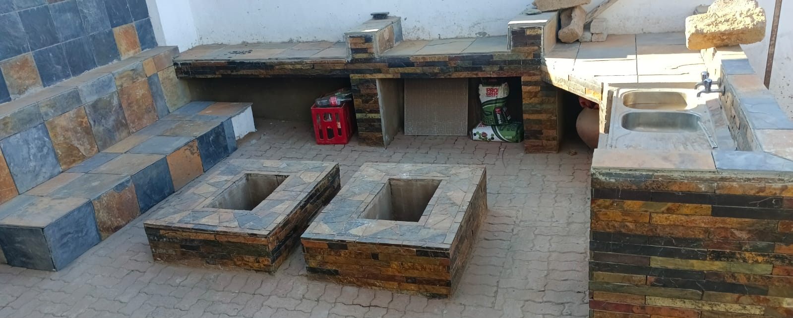 Slate outdoor entertainment area with fire pits and sink